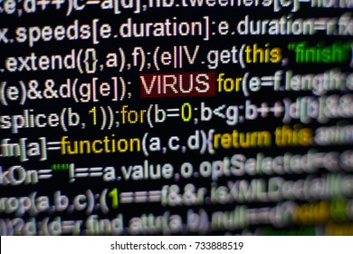 Macro photo of computer screen with program source code and highlighted VIRUS inscription in the middle. Script on the screen with virus in it. Cyber security concept. Technology background.