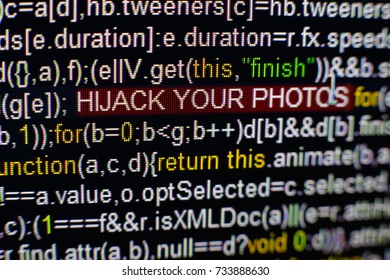 Macro photo of computer screen with program source code and highlighted HIJACK YOUR PHOTOS inscription in the middle. Script on the screen with virus in it. Cyber security concept. Technology