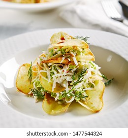 Macro Photo Of Exquisite Serving Salad With Crispy Potato Chips And Chopped Strips Vegetables On Blurred Background. Restaurant Starter Menu Of Veggie Salat With Thin Sliced Fried Potatoes Close Up