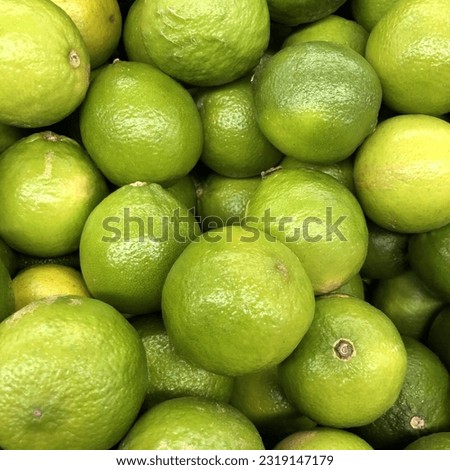 Macro photo fresh lime fruits. Stock photo citrus green lime fruits background