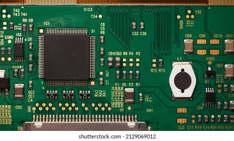 Macro photo of a green computer printed circuit board with selective focus on an blank chip.