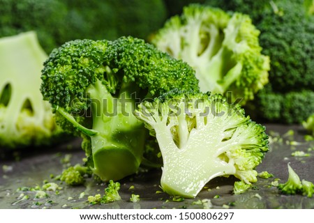 Macro photo green fresh vegetable broccoli. Fresh green broccoli on a black stone table.Broccoli vegetable is full of vitamin.Vegetables for diet and healthy eating.Organic food. 