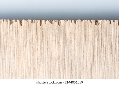 Macro Photo Of Plywood Edge Over A White Background