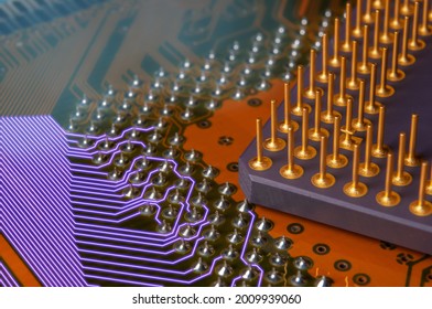 Macro Photo Of Printed Circuit Board With Illuminated Wires, Pin Grid Array And Processor With Golden Pins