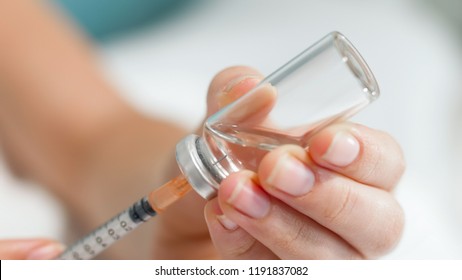 Macro photo of syringe needle in ampule with medicines