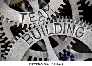 Macro Photo Of Tooth Wheel Mechanism With TEAM BUILDING Letters Imprinted On Metal Surface