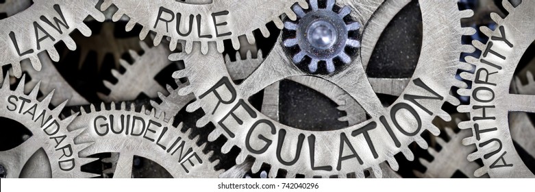 Macro photo of tooth wheel mechanism with REGULATION, LAW, RULE, AUTHORITY, GUIDELINE and STANDARD words imprinted on metal surface - Shutterstock ID 742040296