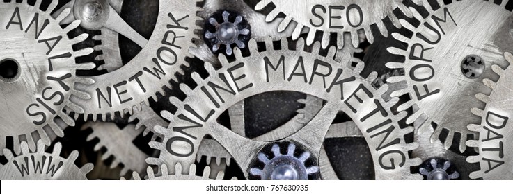 Macro photo of tooth wheel mechanism with ONLINE MARKETING concept related words imprinted on metal surface