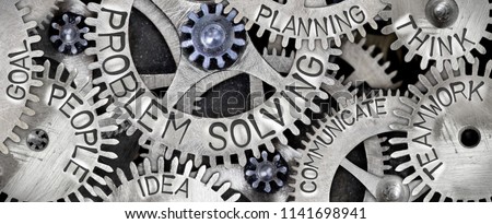 Macro photo of tooth wheel mechanism with PROBLEM SOLVING concept related words imprinted on metal surface