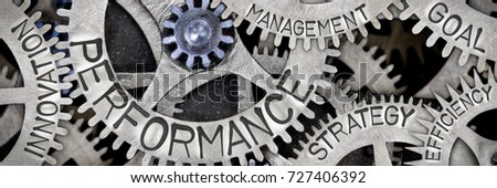 Macro photo of tooth wheel mechanism with PERFORMANCE, EFFICIENCY, INNOVATION, STRATEGY, MANAGEMENT and GOAL concept letters