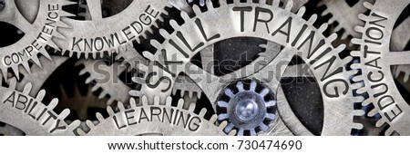 Macro photo of tooth wheel mechanism with SKILL TRAINING, EDUCATION, LEARNING, ABILITY, KNOWLEDGE and COMPETENCE words imprinted on metal surface