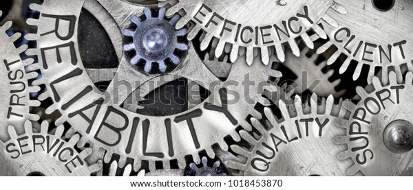 Macro photo of tooth\
wheel mechanism with RELIABILITY concept related words imprinted on\
metal surface