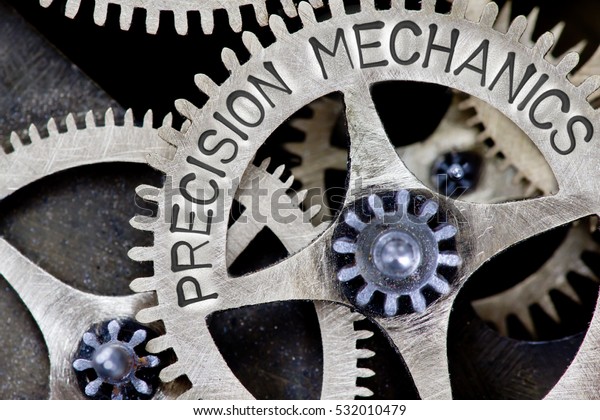 Macro photo of tooth wheel mechanism with\
PRECISION MECHANICS concept\
letters