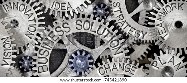 Macro photo of tooth wheel\
mechanism with BUSINESS SOLUTION, PLAN, STRATEGY, CHANGE,\
INNOVATION, VISION, TEAMWORK and IDEA words imprinted on metal\
surface