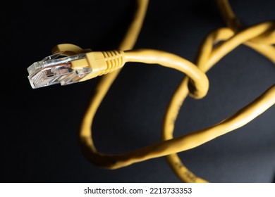 Macro Photo Of A Yellow 8 Pin Ethernet Plug And Cable On A Black Background