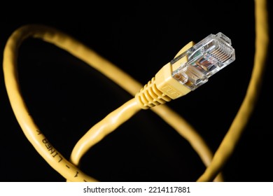 Macro Photo Of A Yellow 8 Pin Ethernet Plug And Cable On A Black Background