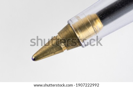 Macro photograph of ball point biro pen. Extremely close up focused on the ball tip.