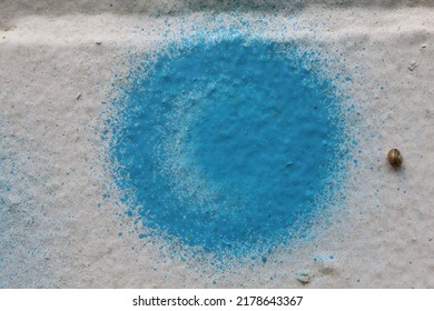 Macro photograph of a spray paint circle on a white brick wall.
