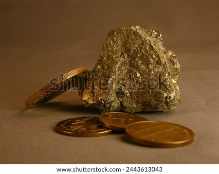 Macro photography of coins next to a pyrite nugget (similar to gold)
