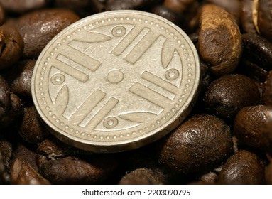 Macro Photography Of A Colombian Peso Among Some Coffee Beans