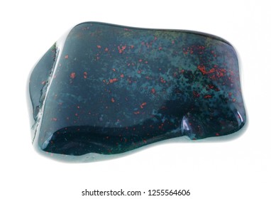 macro photography of natural mineral from geological collection - tumbled heliotrope gem stone (bloodstone) on white background