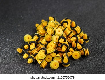 Macro photography of plastic yellow clips for a car on a gray background. Car clips, plastic fasteners.Yellow plastic clips on a gray background close-up.Car clips and fasteners.