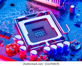 Macro photography of a processor, microprocessor with pins up on a computer motherboard. Neon lighting. Technological background. Computer components, digital equipment, engineering.