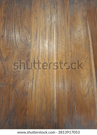 Macro photography of a solid timber tabletop in a diner, revealing detailed woodgrain patterns, lines, and knots as an abstract natural backdrop.