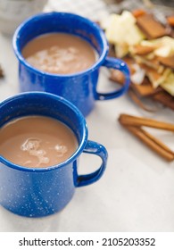 Macro Photography. Two Cups Of Coffee With Milk, Cinnamon Sticks, Sweets On A Light Background. Romantic Date, Valentine's Day, Family Comfort, Breakfast For Two. There Are No People In The Photo.