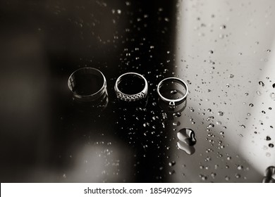 Macro photography wedding rings in water drops, engagement rings symbolizing love, black and white photo with colorful shades. - Powered by Shutterstock