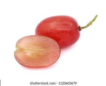 Macro picture of whole fresh red seedless grape and a cut half one isolated on white background.