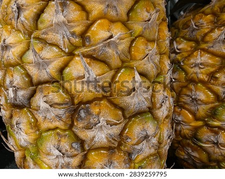 Macro Of Pineapple Peel Pattern With Second Pineapple In The Background