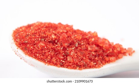 Macro Of Red Confectionary Sugar In White Spoon