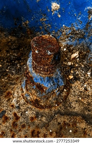 Macro of Rusted Bolt Stud with Flaking Blue Paint - Heavy Industrial Corrosion Texture Detail for Steampunk Design