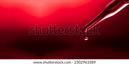 Macro science experiment pipette surface, top macro view of chemical droplet injecting oil into clear liquid in one of three petri dishes on red background. Abstract skincare cosmetics concept. 