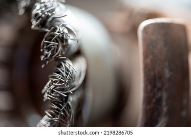 Macro Selective Focus On The Bristle Ends Of A Wire Brush Wheel On A Grinder.