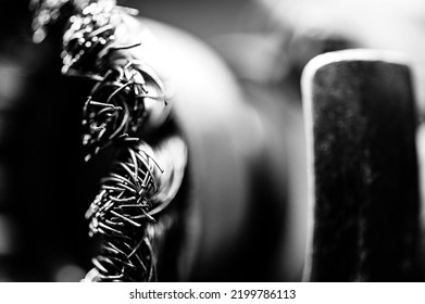 Macro Selective Focus On The Bristle Ends Of A Wire Brush Wheel On A Grinder.