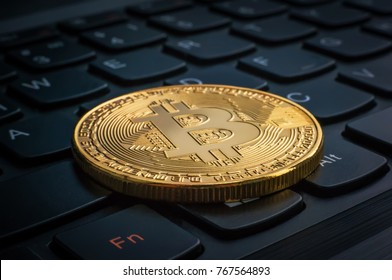 macro shiny bitcoin on computer keyboard. virtual cryptocurrency concept. Electronic money mining concept