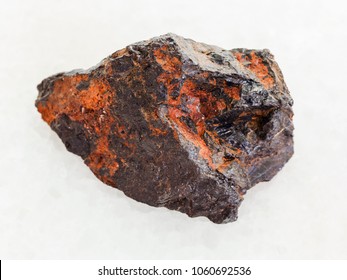 Macro Shooting Of Natural Mineral Rock Specimen - Raw Wolframite Stone (tungsten Ore) On White Marble Background From Zabaykalsky Krai Of Russia