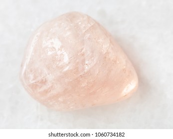 macro shooting of natural mineral rock specimen - polished morganite (pink beryl) gemstone on white marble background from Ural Mountains, Russia - Shutterstock ID 1060734182