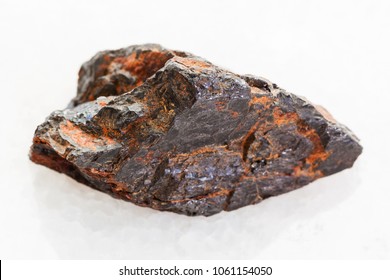 Macro Shooting Of Natural Mineral Rock Specimen - Rough Wolframite Stone (tungsten Ore) On White Marble Background From Zabaykalsky Krai Of Russia