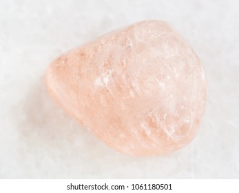 macro shooting of natural mineral rock specimen - tumbled morganite (pink beryl) gemstone on white marble background from Ural Mountains, Russia - Shutterstock ID 1061180501