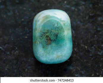 Macro Shooting Of Natural Mineral Rock Specimen - Polished Heliotrope Gem Stone On Dark Granite Background