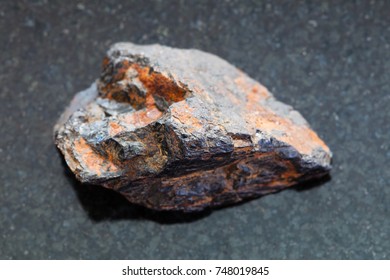 Macro Shooting Of Natural Mineral Rock Specimen - Raw Wolframite Stone (tungsten Ore) On Dark Granite Background From Zabaykalsky Krai Of Russia