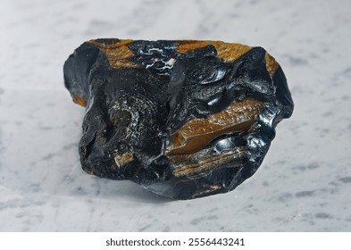 Macro shooting of natural raw gemstone Carnelian mineral on light marble polished slab close-up. Raw sard (brown carnelian), a variety of chalcedony. Selective focus. - Powered by Shutterstock