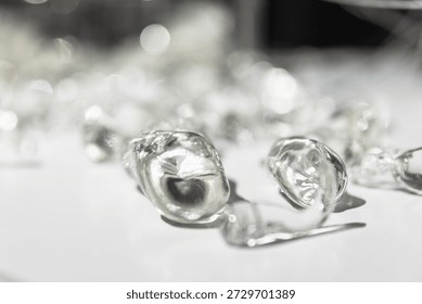 Macro shot of an abstract metallic objects scattered on a bright white surface