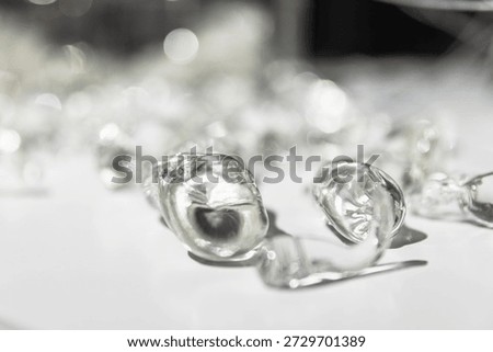 Macro shot of an abstract metallic objects scattered on a bright white surface