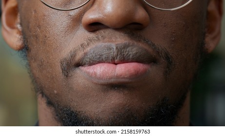 Macro Shot Of African American Person Moving His Lips In Front Of Camera, Having Natural Healthy Skin. Authentic Man With Short Heaired Beard And Moustache Smiling, Having Clean Trim. Close Up.