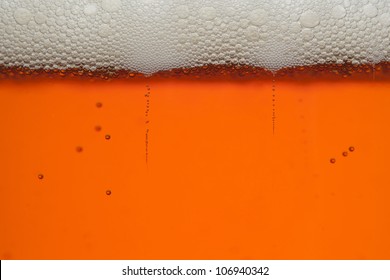 Macro Shot Of Amber Beer With Bubbles And Head