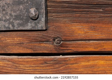 Macro Shot Of An Ancient Weathered Dark Brown Cracked Wood Beam Surface With Nice Rough Grain Texture.